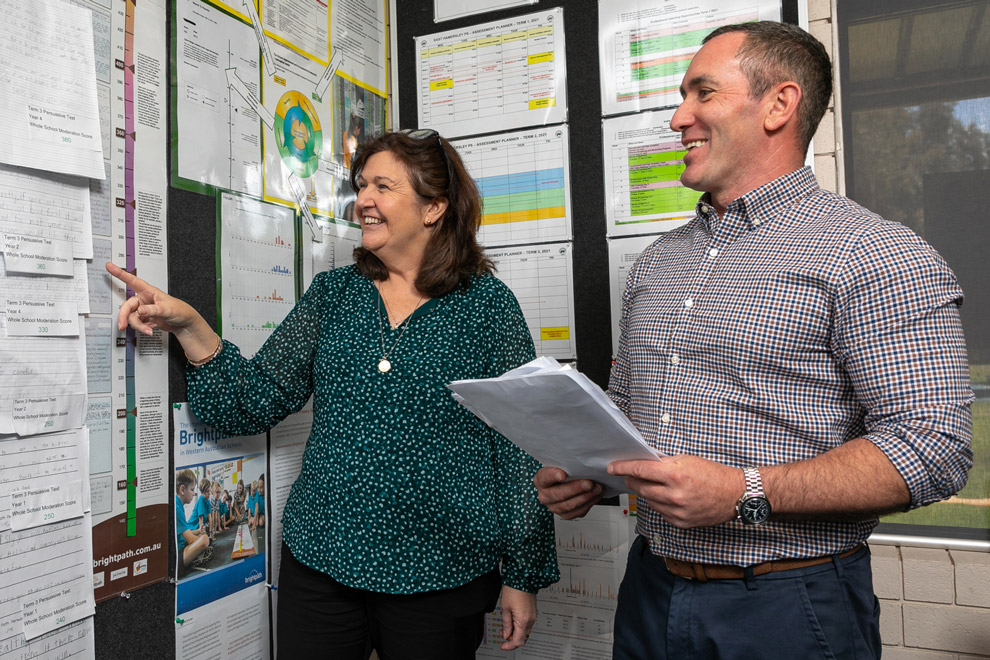 Two teachers looking at a Brightpath ruler.
